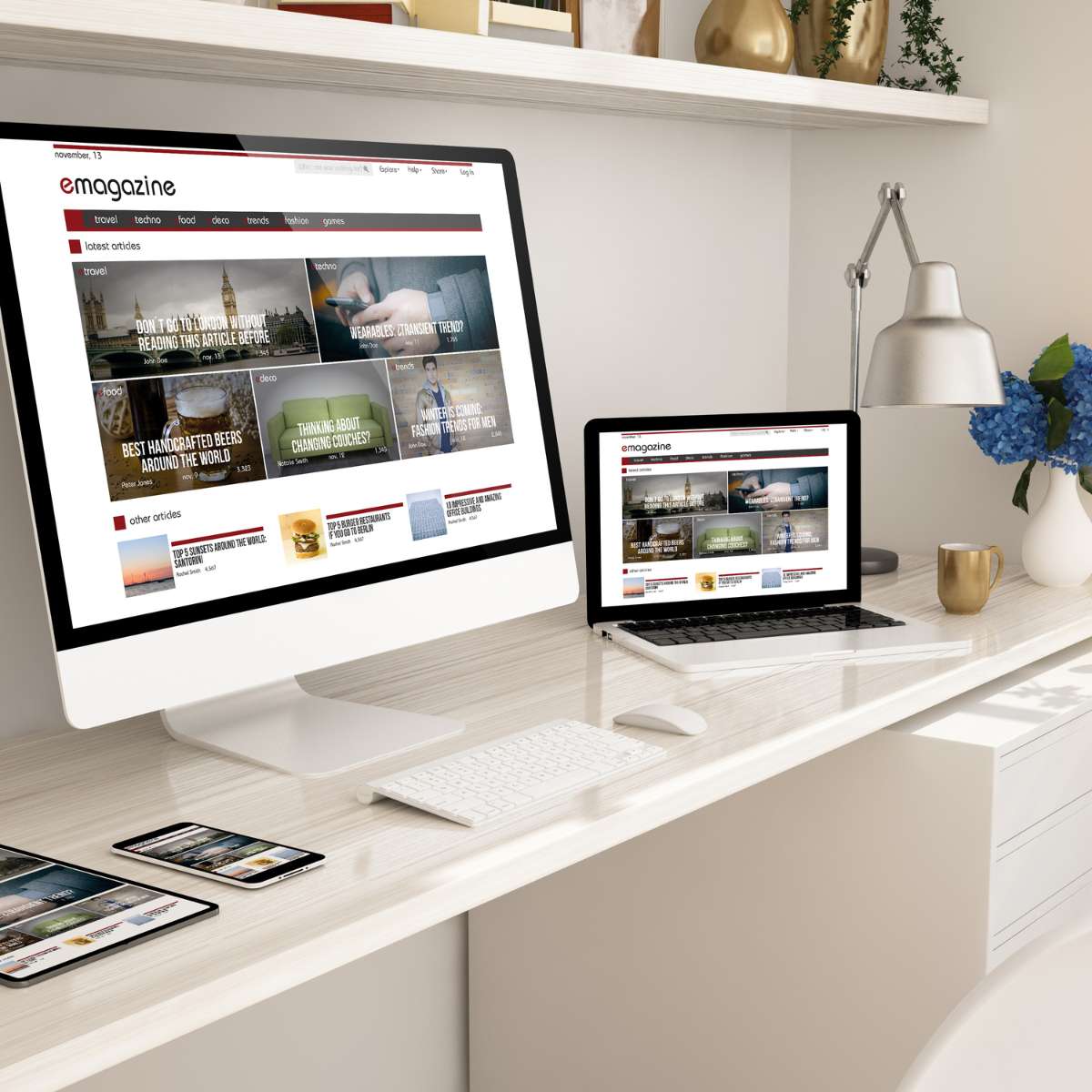 A digital magazine and portfolio website design by AUZ Studio, displayed on an iMac, MacBook, and tablet in a bright office, featuring a grid layout of articles with travel and lifestyle photography.